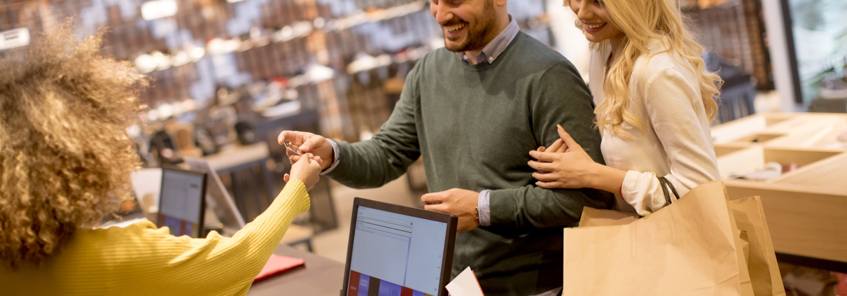 young couple paying female sales assistant with cr 2022 04 04 22 19 04 utc min
